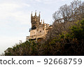 Gothic castle on a rock against a cloudy sky and 92668759