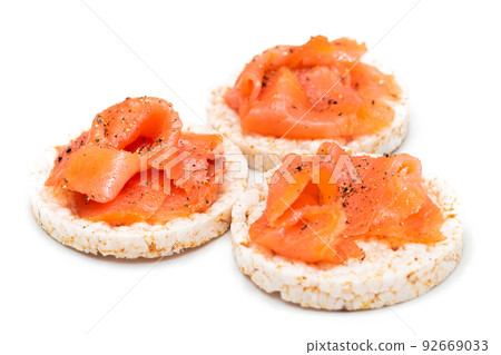 Rice Cake Sandwiches with Fresh Salmon Slices Isolated on White Rice Cake Sandwiches with Fresh Salmon Slices Isolated on White 92669033