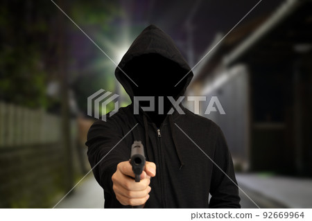 A person with a gun who appeared in a residential area A person with a gun who appeared in a residential area 92669964