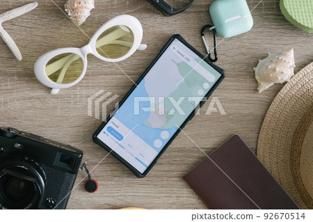 top view travel concept with retro camera films, smartphone, map, passport, compass and Outfit of traveler, Tourist essentials. 92670514