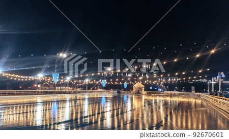 Night skating rink with nobody on clear mirror ice 92670601