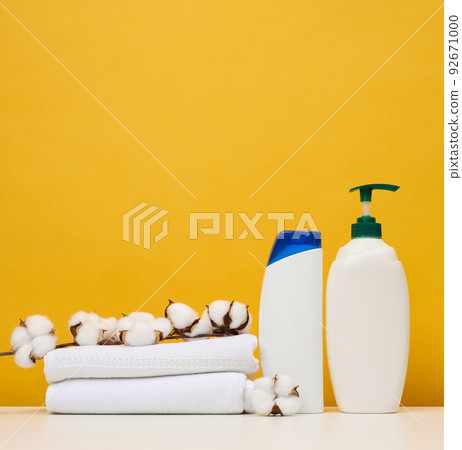 White plastic bottles for gel and shampoo and rolled white terry towels White plastic bottles for gel and shampoo and rolled white terry towels 92671000