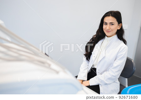 Portrait of young female dentist in office 92671680
