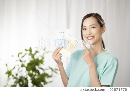 A female pharmacist with a smile and a medicine bag and a medicine notebook 92671776