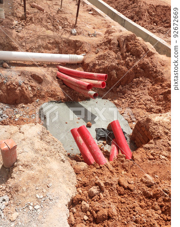 SELANGOR, MALAYSIA -AUGUST 2, 2021: Heavy-duty underground pipes lay in the ground at a construction site. this pipe will be the path to the high voltage electric cable. 92672669