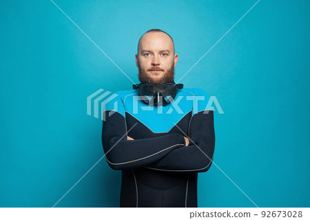 Scuba diver man isolated on blue background Scuba diver man isolated on blue background 92673028