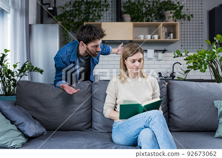 An evil husband quarrels at home and beats his wife, family conflict 92673062