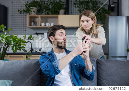 Jealous wife quarrels over husband who uses phone, and keeps in touch with mistress, family quarrel and conflict Jealous wife quarrels over husband who uses phone, and keeps in touch with mistress, family quarrel and conflict 92673122