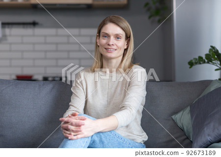 Portrait of a successful and happy woman at home, smiling and looking at the camera 92673189