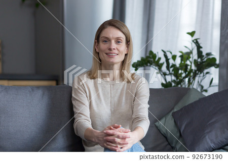 Portrait of a successful and happy woman at home, smiling and looking at the camera 92673190