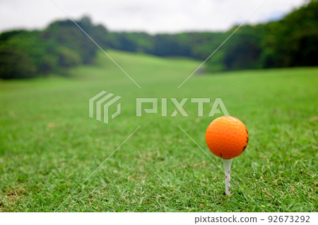 View from the teeing ground of a golf course and a teed orange golf ball (Futtsu City, Chiba Prefecture) View from the teeing ground of a golf course and a teed orange golf ball (Futtsu City, Chiba Prefecture) 92673292