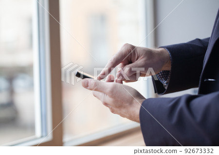 Close up of a man using mobile smart phone Close up of a man using mobile smart phone 92673332