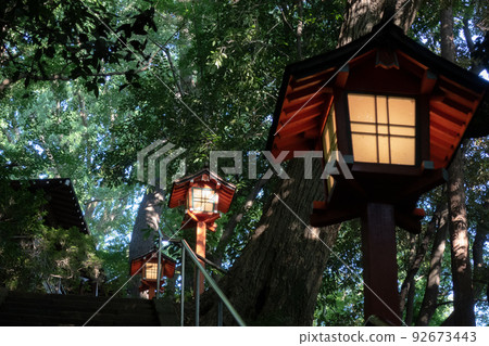 Lanterns at a shrine and sunlight filtering through the trees on a summer day 92673443