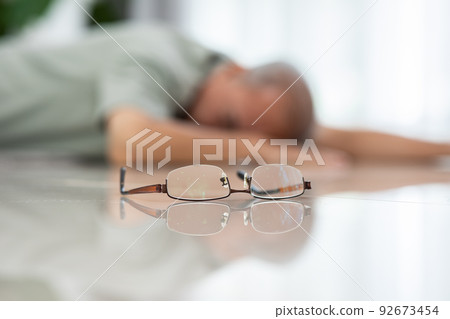 Senior Asian man falling down from chair unconsciousness alone at home. Accident in elderly man down on the floor lose consciousness or hearth attack. Elderly symptom and sudden pain. Elder care Senior Asian man falling down from chair unconsciousness alone at home. Accident in elderly man down on the floor lose consciousness or hearth attack. Elderly symptom and sudden pain. Elder care 92673454
