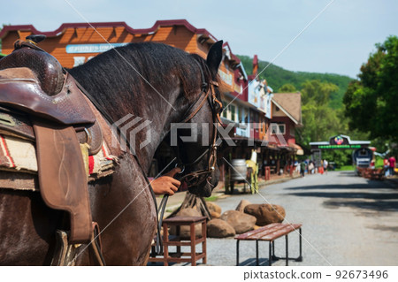 cowboy horse with blur old wood village 92673496