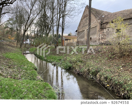 european countryside stream and old house 92674558