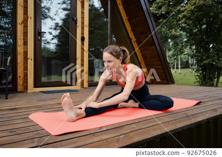 Knee-to-head forward fold pose Knee-to-head forward fold pose 92675026