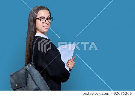 Teenage female student with backpack notebooks on color background Teenage female student with backpack notebooks on color background 92675266