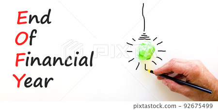 EOFY end of financial year symbol. Concept words EOFY end of financial year on white paper on beautiful white background. Black calculator and pen. Business and EOFY end of financial year concept. 92675499