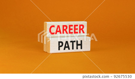 Career path symbol. Concept words Career path on wooden blocks on a beautiful orange table orange background. Business Career path concept. Copy space. 92675530