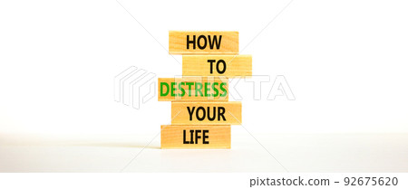 Destress your life symbol. Concept words How to destress your life on wooden blocks. Beautiful white table white background. Copy space. Psychological business destress your life concept. Copy space. 92675620