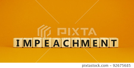 Impeachment symbol. Wooden cubes with the word 'impeachment'. Beautiful orange background, copy space. Business, impeachment concept. 92675685