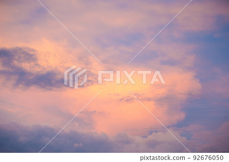 Sunset sky with colorful clouds. Blue colors merge with soft orange 92676050