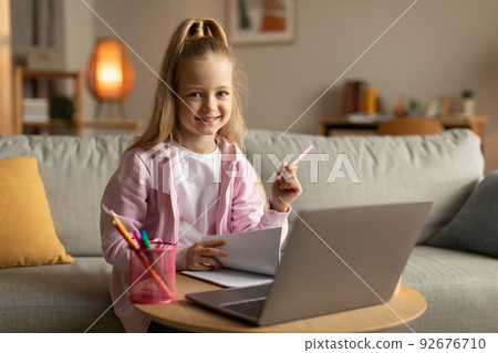 Schoolgirl At Laptop Computer Taking Notes Learning Online At Home Schoolgirl At Laptop Computer Taking Notes Learning Online At Home 92676710