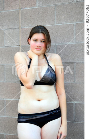 Female beauty wearing a bikini outdoors. 92677063