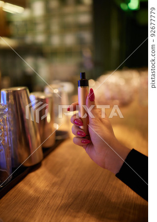 middle aged woman is exhaling vape smoke. 92677779