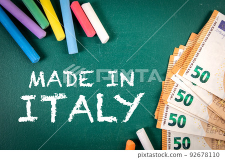 Made in Italy. Euro money and pieces of chalk on a green board Made in Italy. Euro money and pieces of chalk on a green board 92678110
