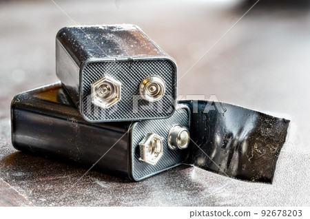9 volt dead battery with terminals covered with electrical tape for safety 9 volt dead battery with terminals covered with electrical tape for safety 92678203