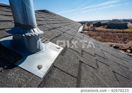 Flashing and weather sealing on vent chimney on a shingle roof 92678233