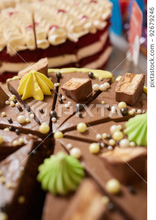 close up of a delicious marshmallow and chocolate topped funnel cake at an outdoor festival. close up of a delicious marshmallow and chocolate topped funnel cake at an outdoor festival. 92679246