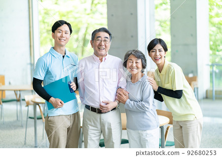 Caregiver and senior couple Caregiver and senior couple 92680253