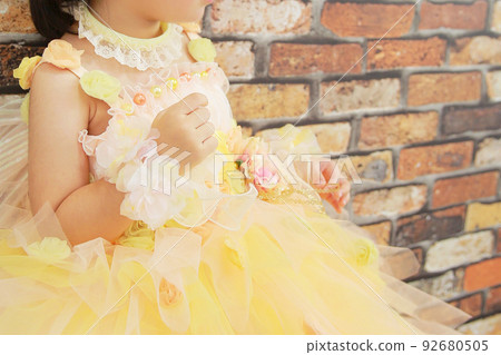 A girl in a yellow dress looking into the distance A girl in a yellow dress looking into the distance 92680505