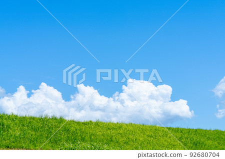 Blue sky, white clouds and summer grass Blue sky, white clouds and summer grass 92680704