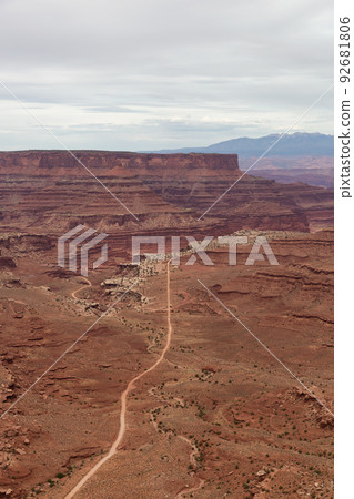 Scenic Dirt Road surrounded by Red Rock Mountains in Desert Canyon. Scenic Dirt Road surrounded by Red Rock Mountains in Desert Canyon. 92681806
