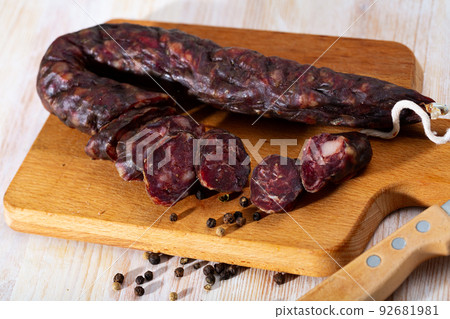 French tasty meal dry-cured sausage with liver at wooden desk French tasty meal dry-cured sausage with liver at wooden desk 92681981