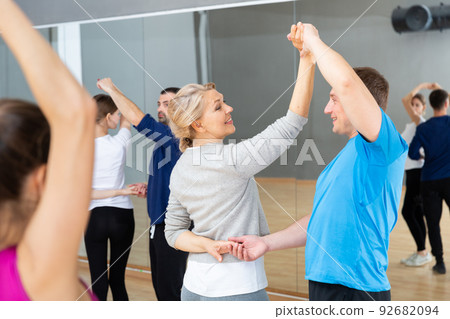 Mature dancing couple during group class Mature dancing couple during group class 92682094