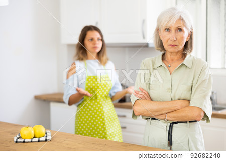 Offended old woman quarreling with her daughter at home Offended old woman quarreling with her daughter at home 92682240