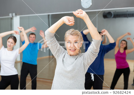 Mature woman practicing vigorous dance Mature woman practicing vigorous dance 92682424