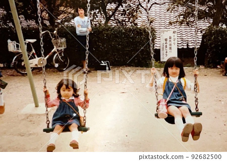 Showa 50's: Good sisters playing on a swing 92682500