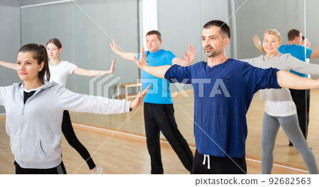 Females and males stretching at dance class Females and males stretching at dance class 92682563