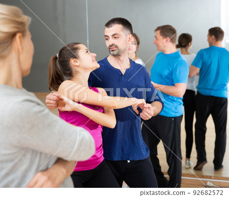 People dancing social dances in pair 92682572