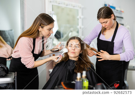 Young woman visiting beauty parlor for hairstyling and makeup Young woman visiting beauty parlor for hairstyling and makeup 92682573