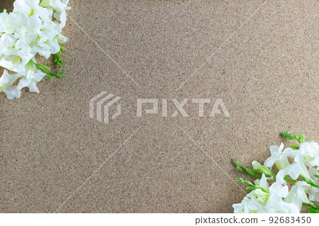Frame made of white flowers on a brown background, Flat lay, copy space,border design. Frame made of white flowers on a brown background, Flat lay, copy space,border design. 92683450