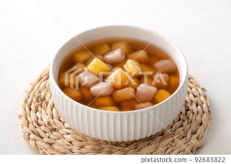 Delicious sweet taro ball soup in a white bowl for serving. 92683822