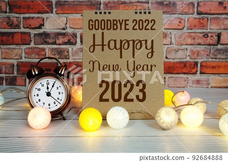 Happy New Year 2023 text message with alarm clock and LED cotton balls decoration Happy New Year 2023 text message with alarm clock and LED cotton balls decoration 92684888