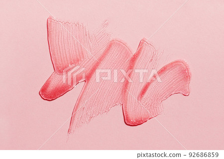 Smears of transparent shining lip gloss on a pink background Smears of transparent shining lip gloss on a pink background 92686859